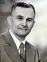 A black and white photo of a man in a suit and tie.