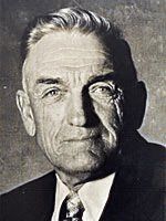 A black and white photo of a man in a suit and tie.