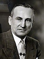 A black and white photo of a man in a suit and tie.