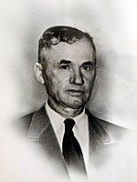 A black and white photo of a man in a suit and tie.