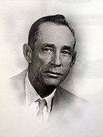 A black and white photo of a man in a suit and tie.