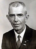 A black and white photo of a man in a suit and tie.