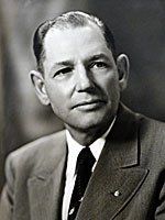 A black and white photo of a man in a suit and tie.