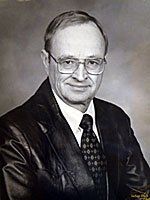A black and white photo of a man in a suit and tie.