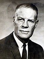 A black and white photo of a man in a suit and tie.