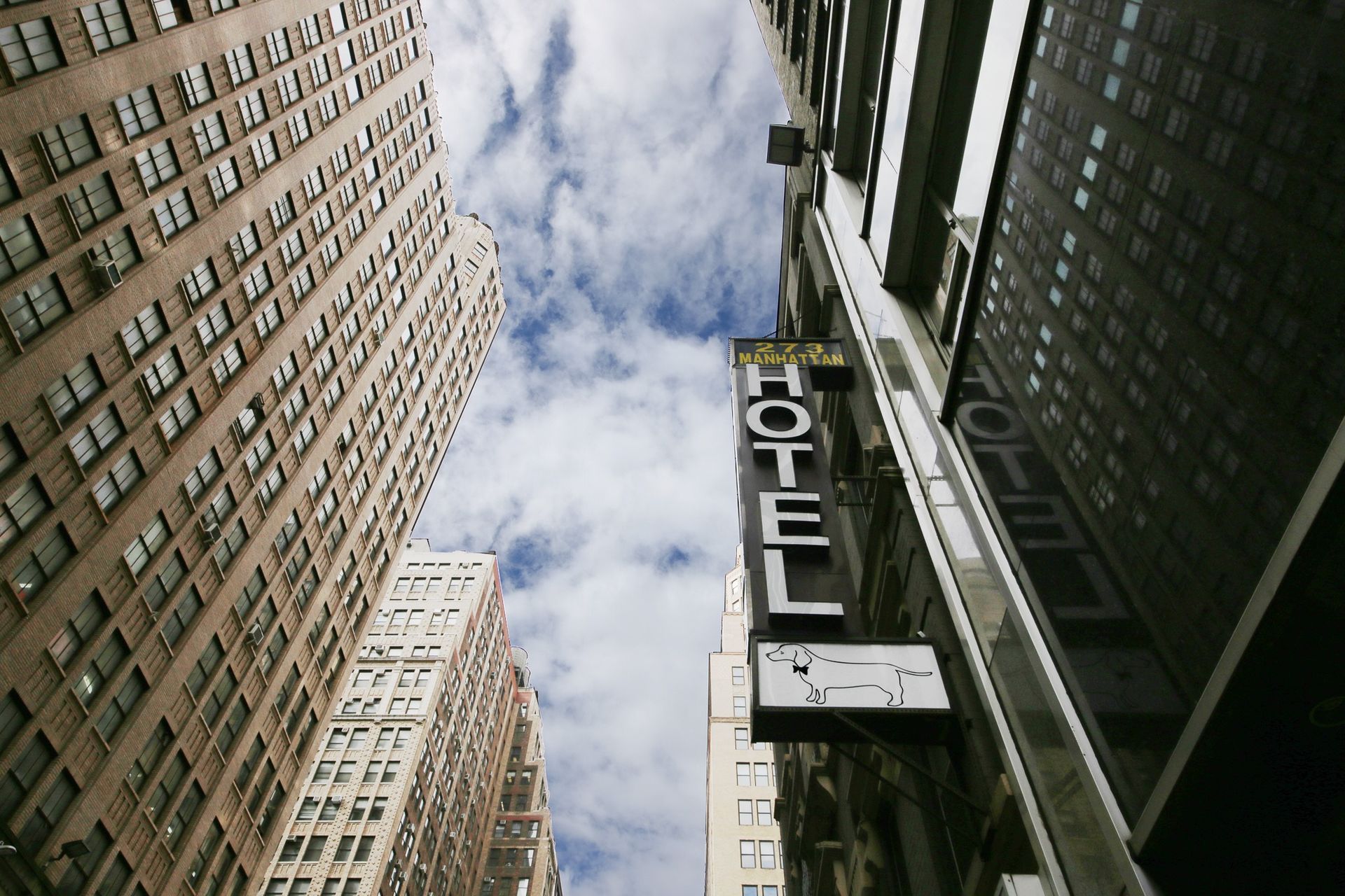 A hotel sign is on the side of a building
