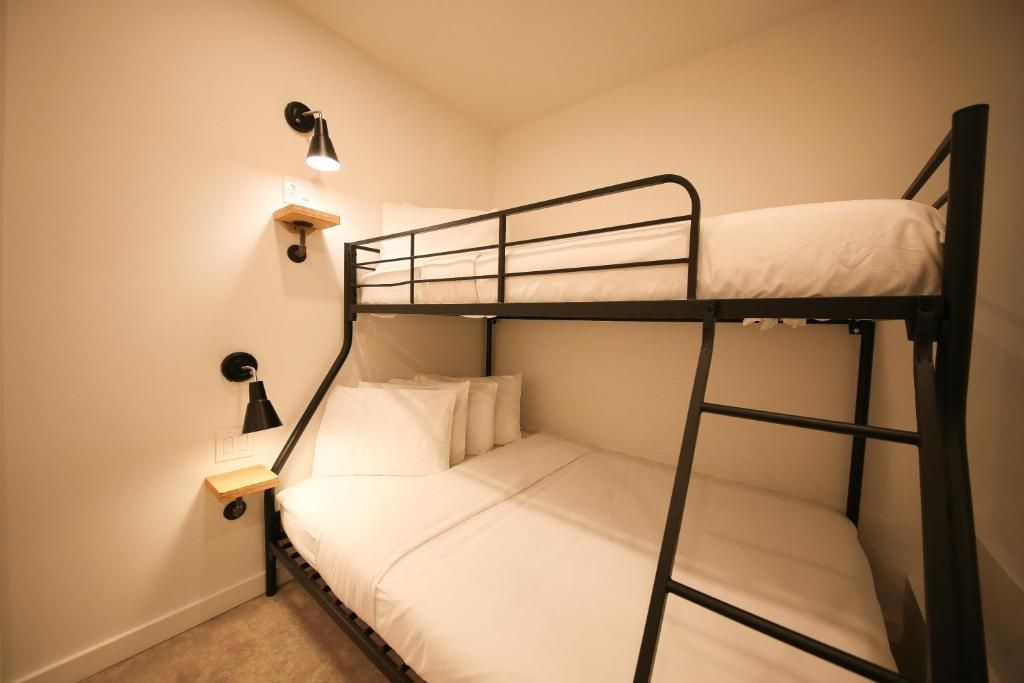 There is a bunk bed in the corner of the room.