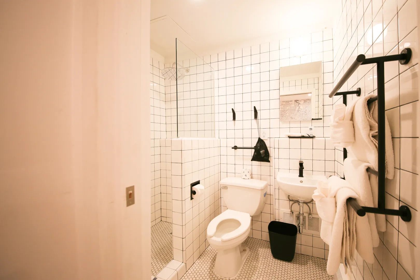 A bathroom with a toilet , sink and mirror.