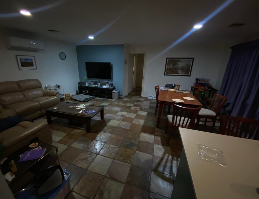 A living room with a couch , table and chairs