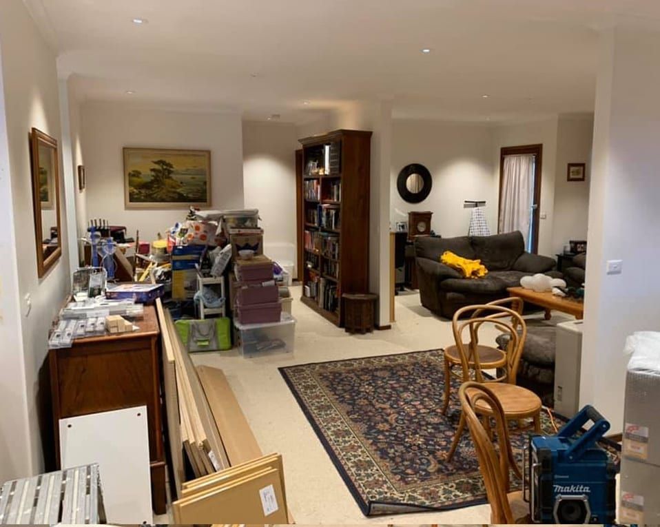 A living room filled with lots of furniture and boxes.