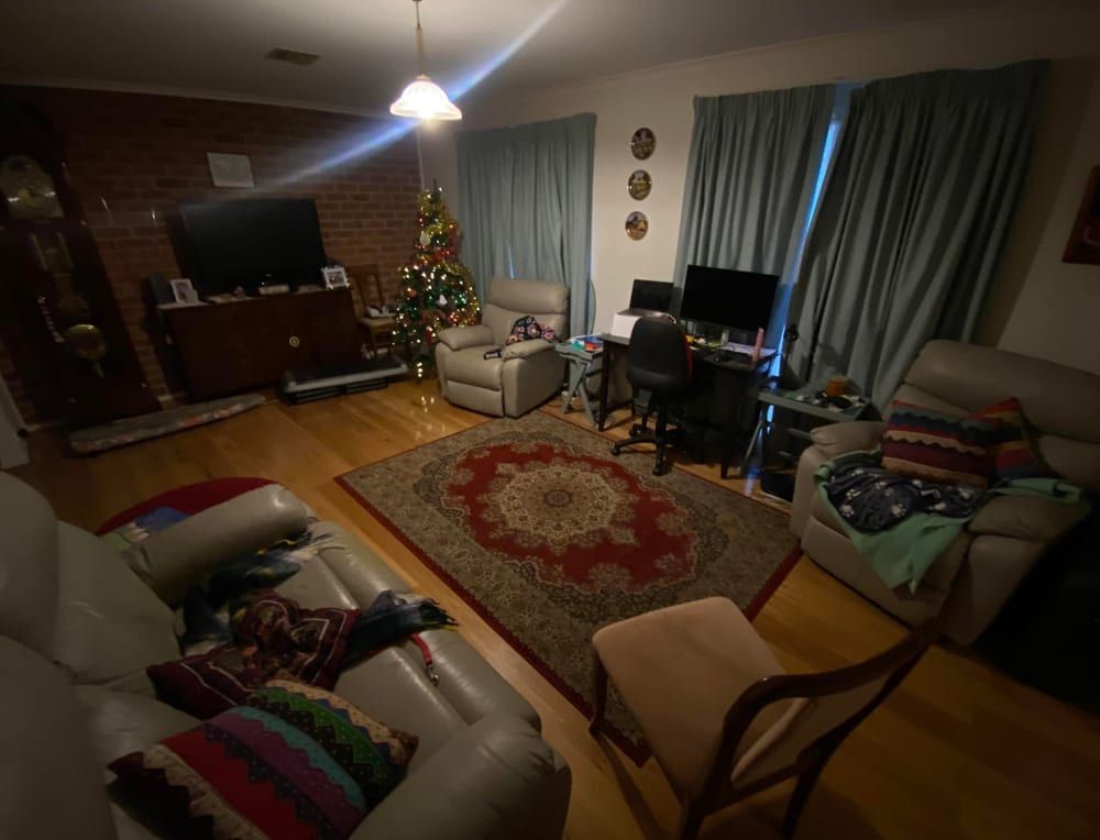 A living room filled with furniture and a christmas tree