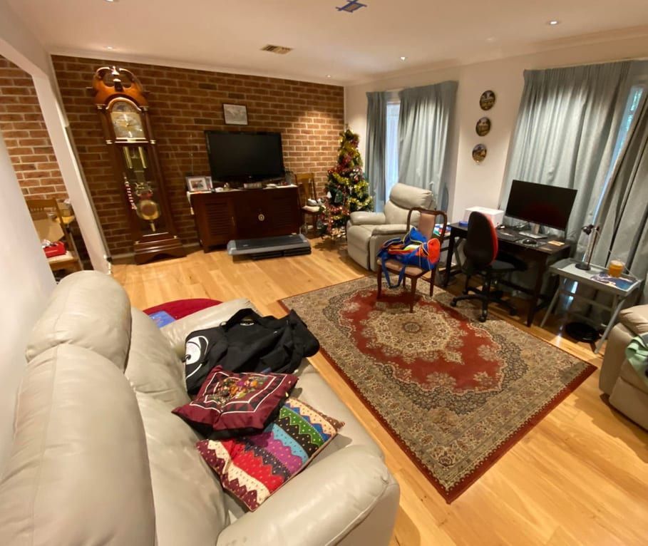 A living room filled with furniture and a clock