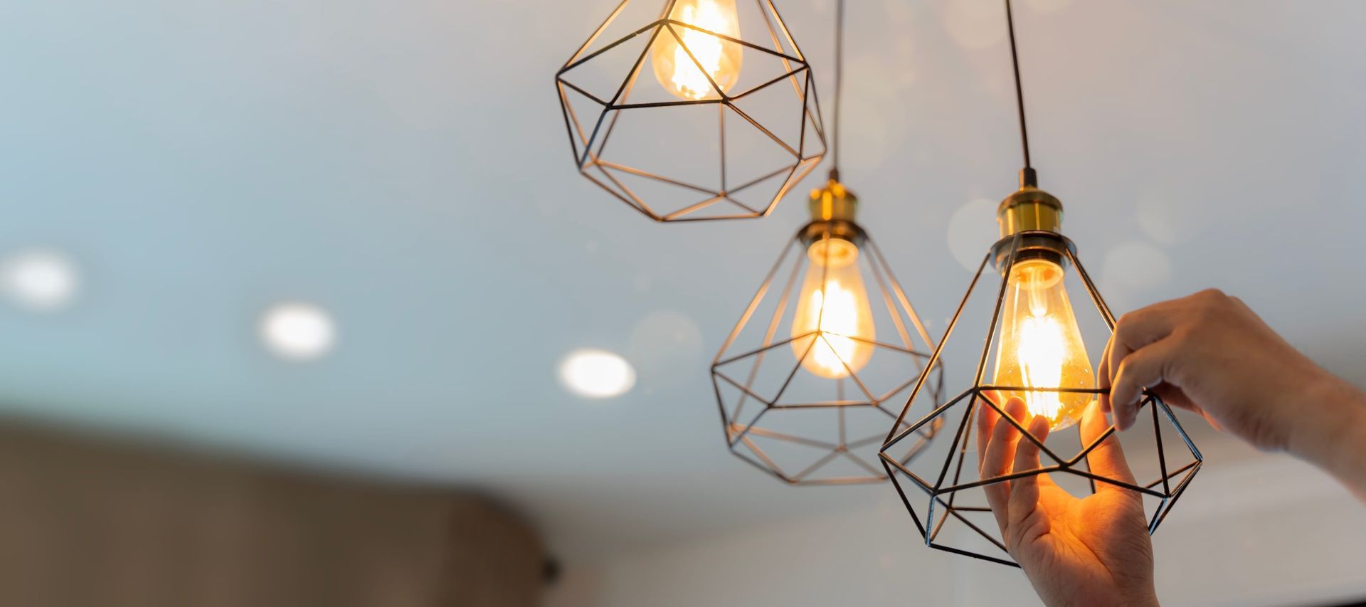 A person is holding a light bulb in their hand.