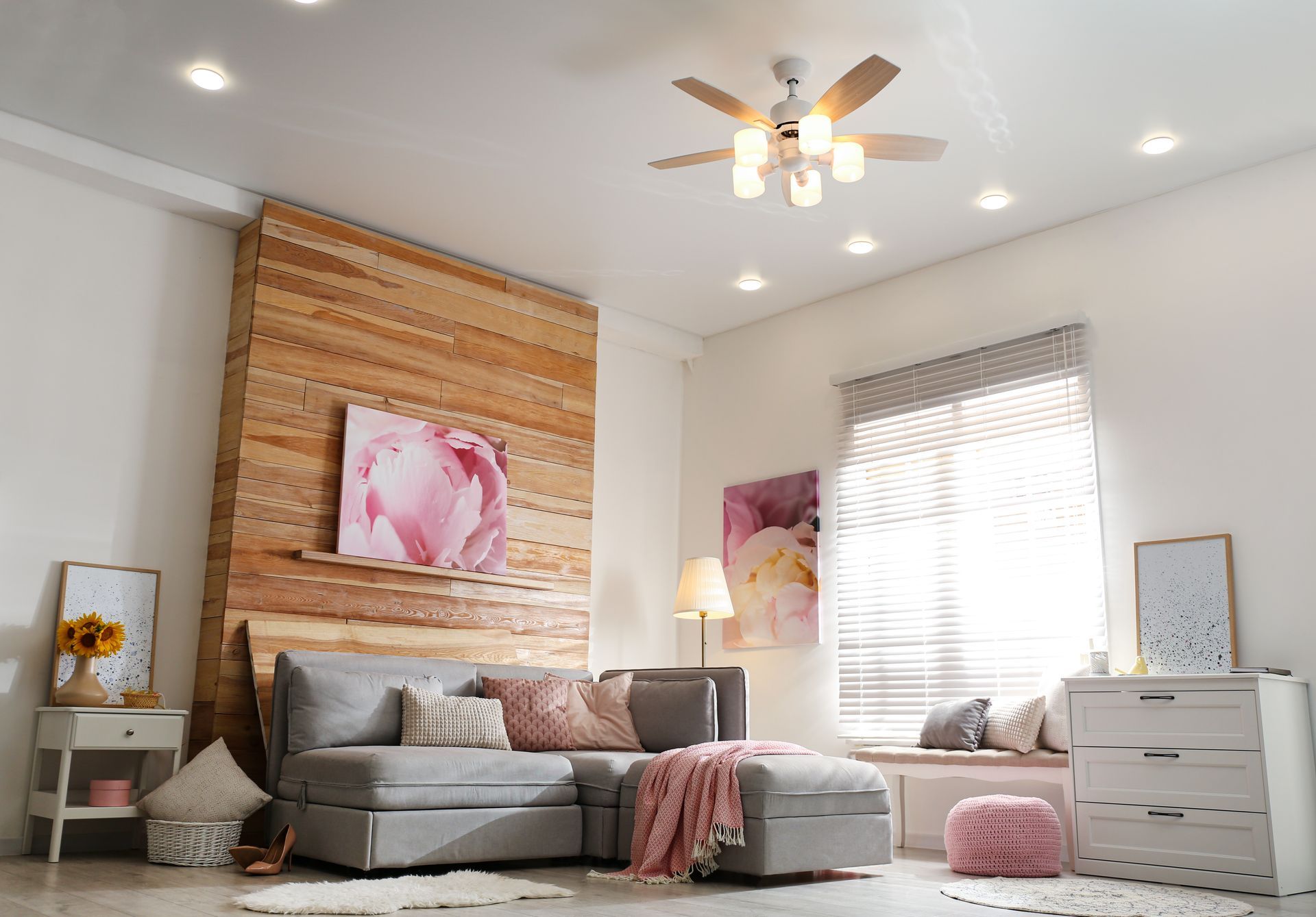A living room with a couch and a ceiling fan.