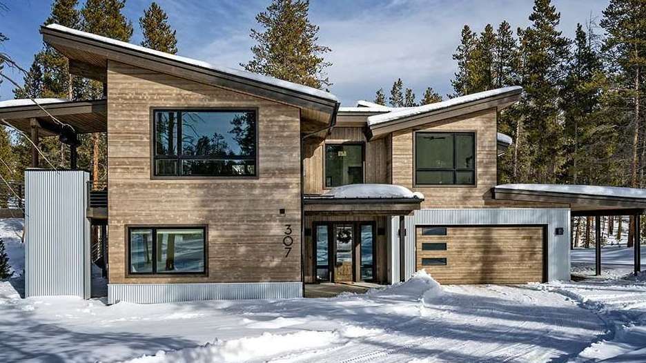 The home features a mountain craftsman style with heavy timber elements.