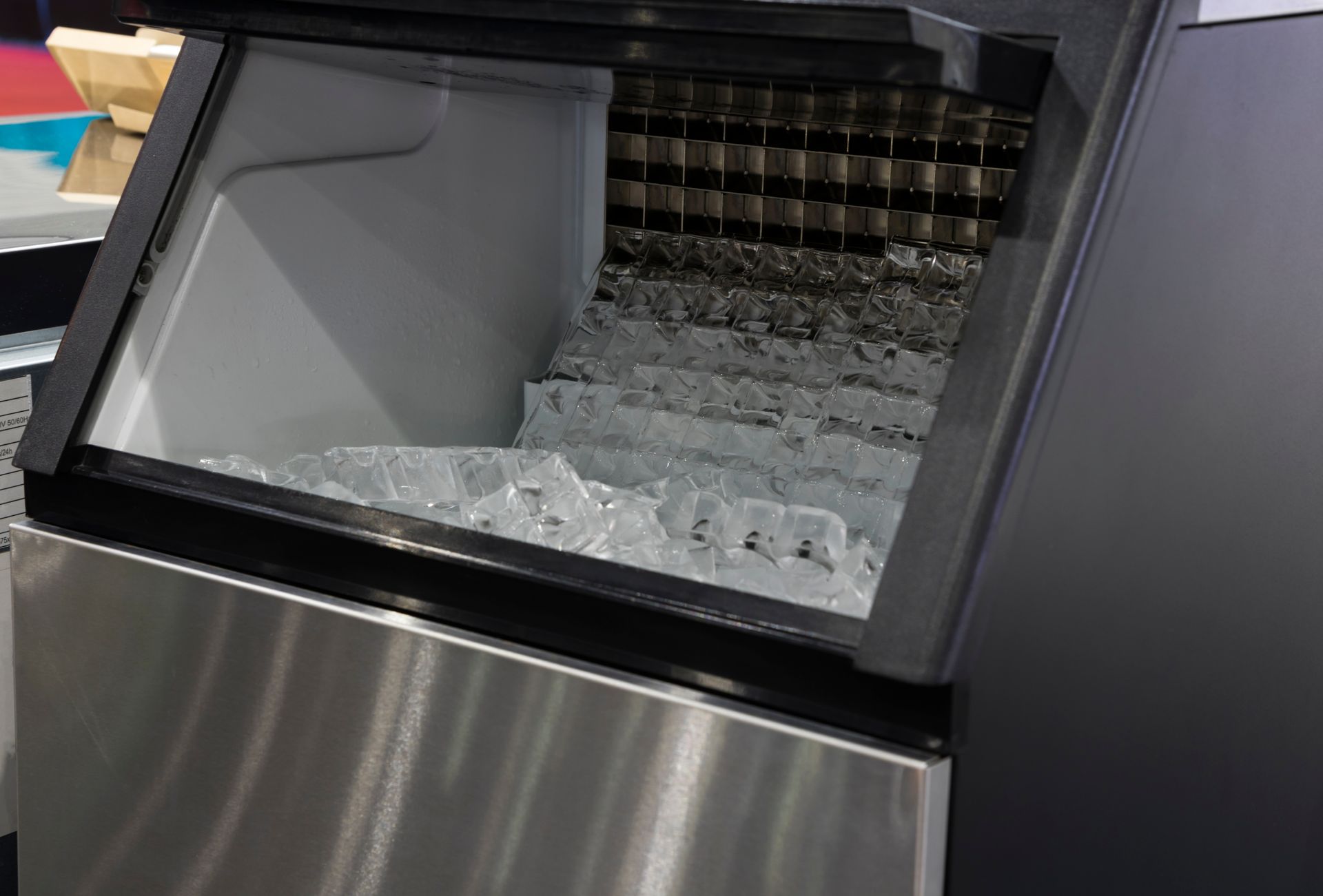 Cube ice in a functioning ice-making machine after professional repair.