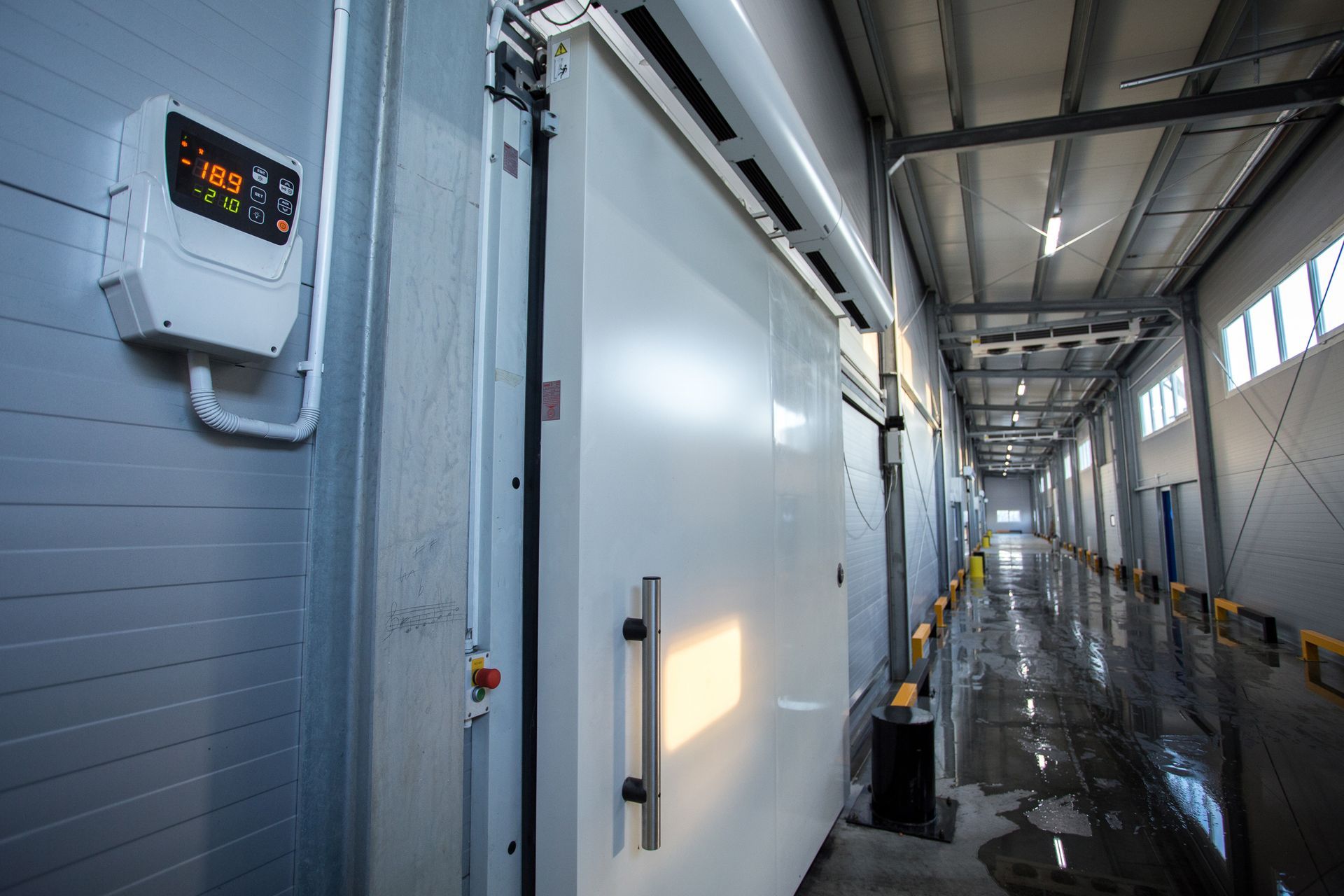 Big refrigerators and large industrial freezers in a warehouse hallway. Big refrigerators and large industrial freezers in a warehouse hallway.