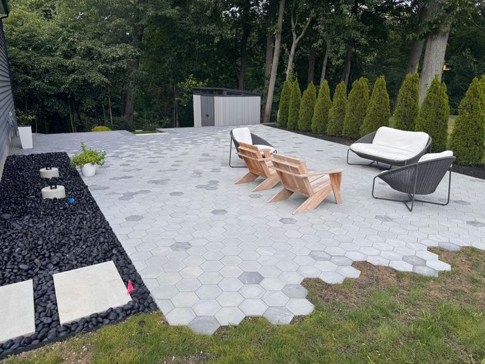 Backyard patio with light hex pavers.