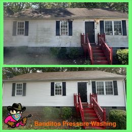 Before-and-after of a white house exterior pressure wash, showing a dirtier top and cleaner bottom with red steps.