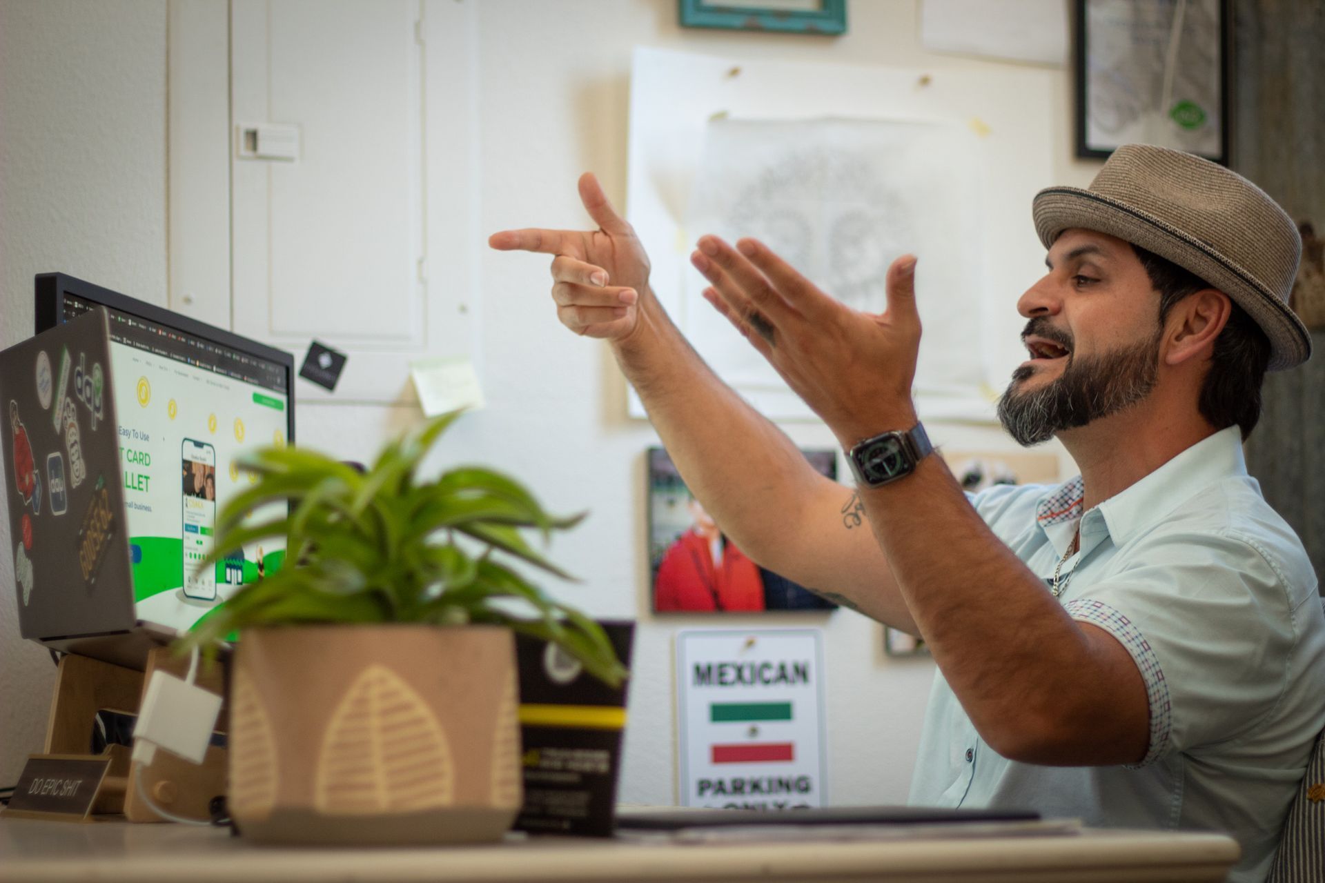 Cesar Torres at his desk talking to customer