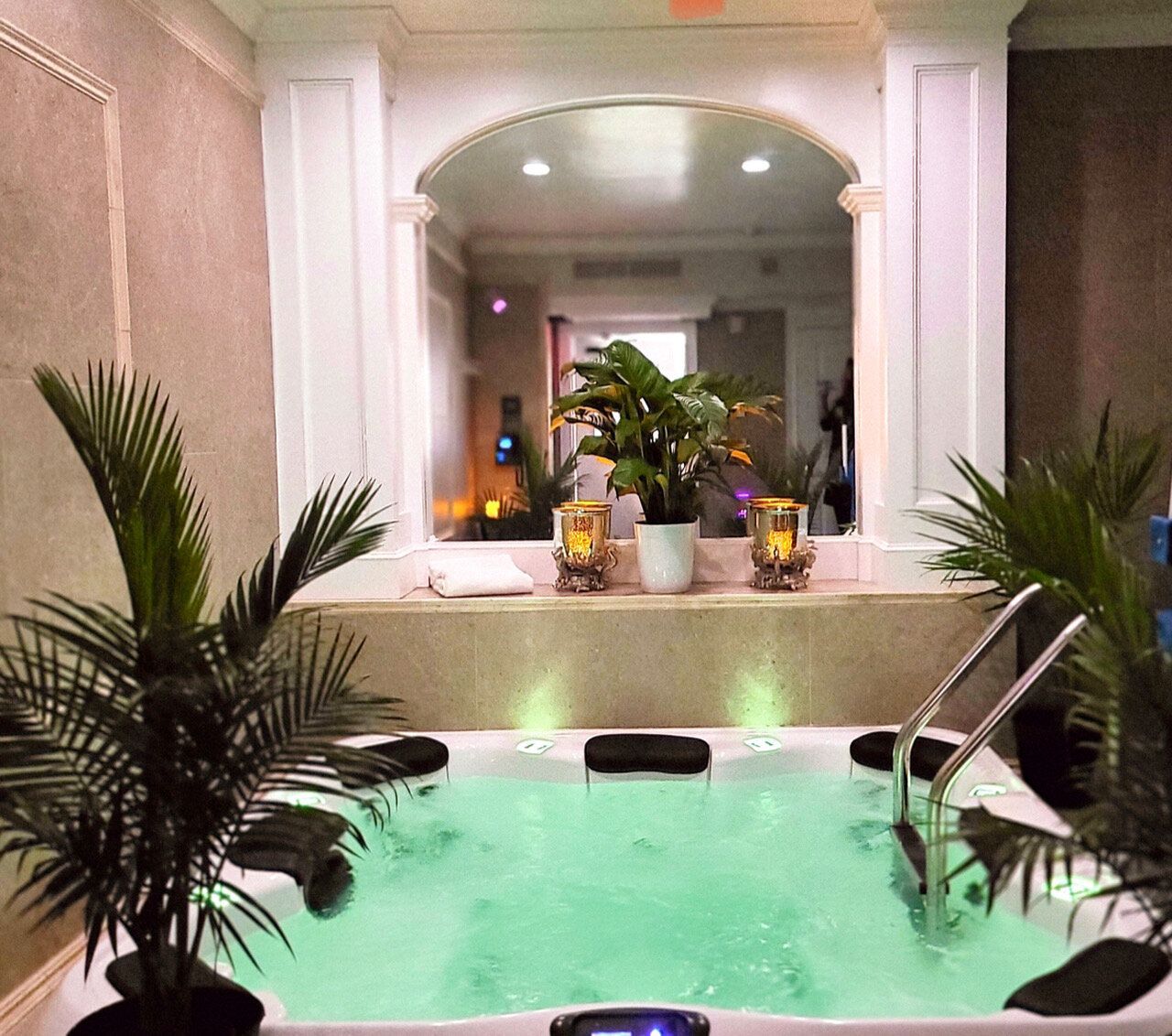 A bathtub with green water and plants in front of it