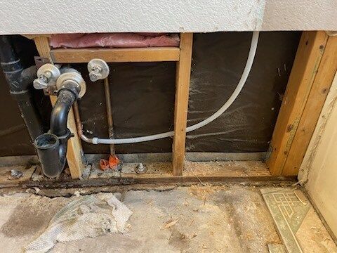 There are a lot of pipes coming out of the wall.