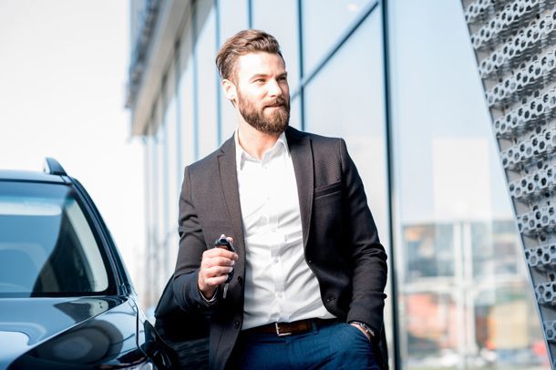 Man Getting Out Of Luxury Car