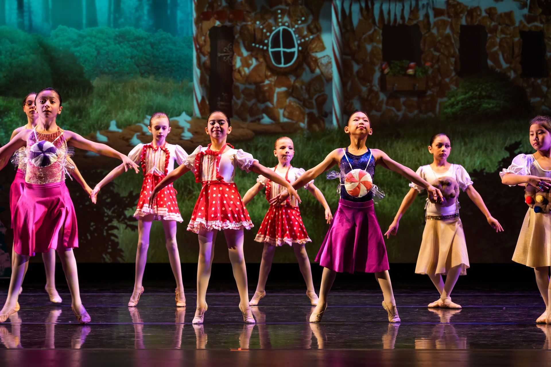 Group of young ballet students sitting on studio floor in leotards and tights. Group of young ballet students sitting on studio floor in leotards and tights.