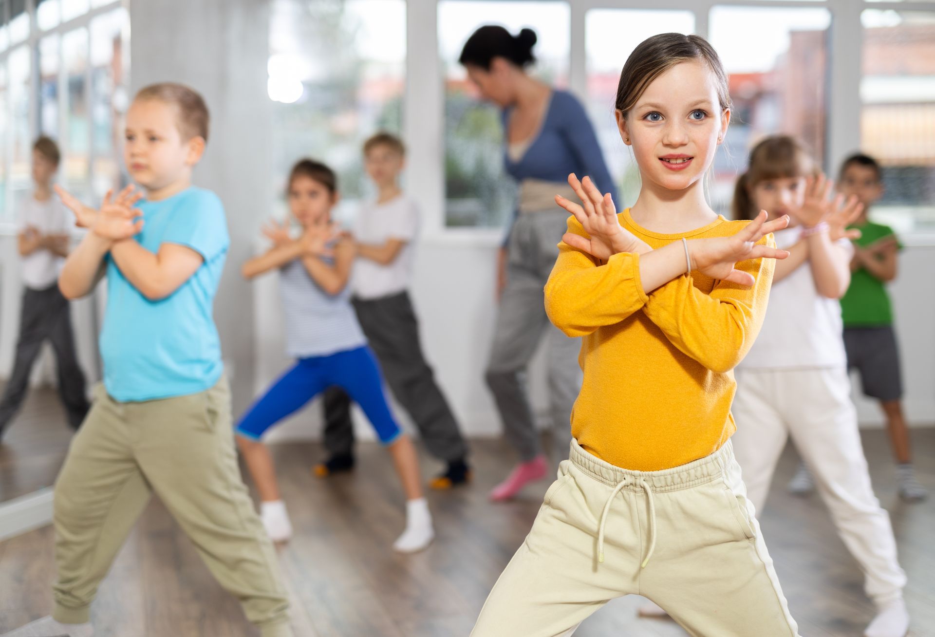 Group of boys and girls rehearsing hip hop dance in studio 