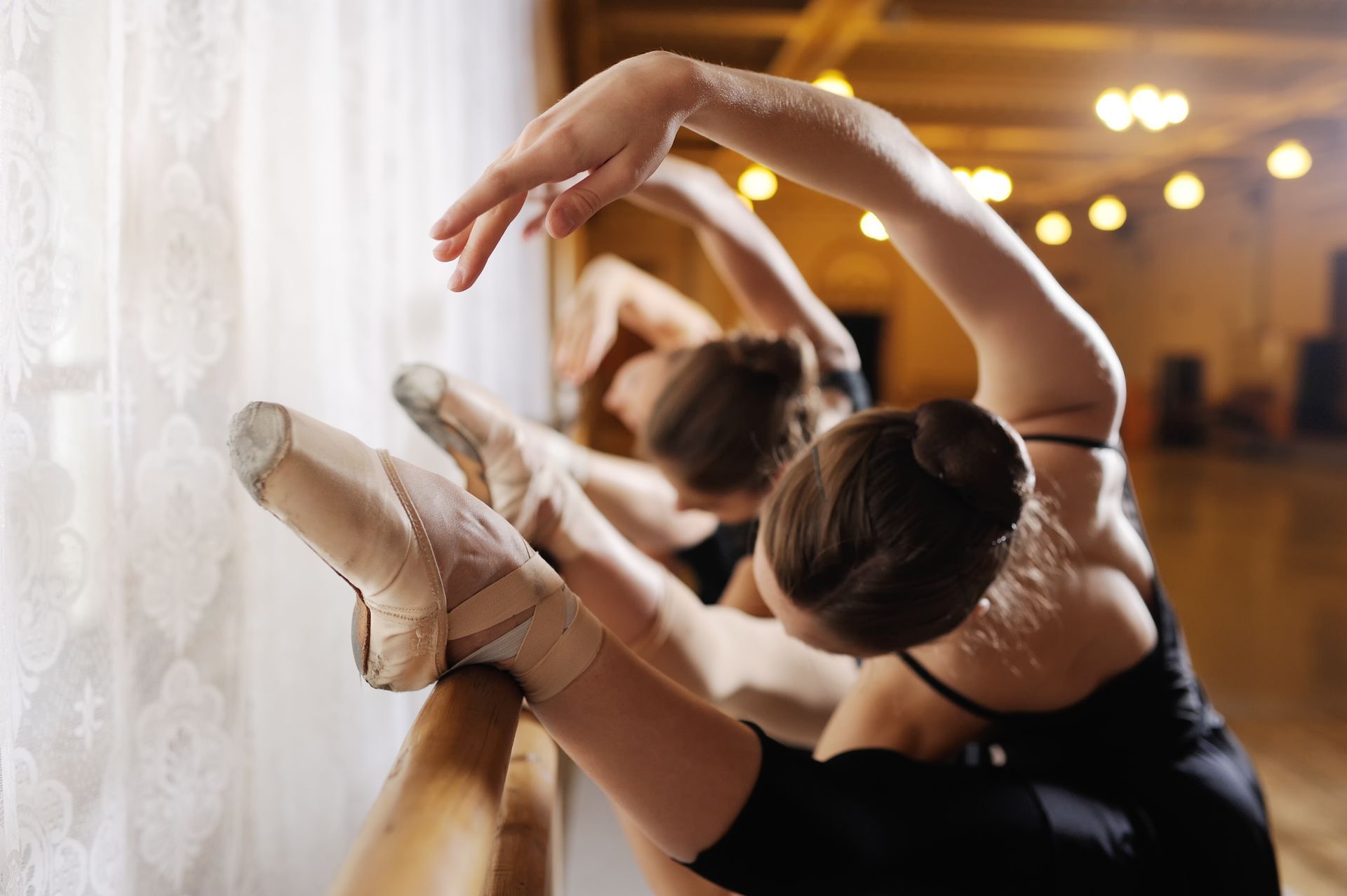 Three ballerinas at a ballet class. Three ballerinas at a ballet class.