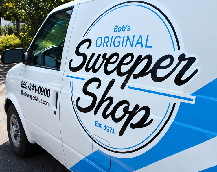 White Bob’s Original Sweeper Shop van with blue logo and phone number parked outdoors