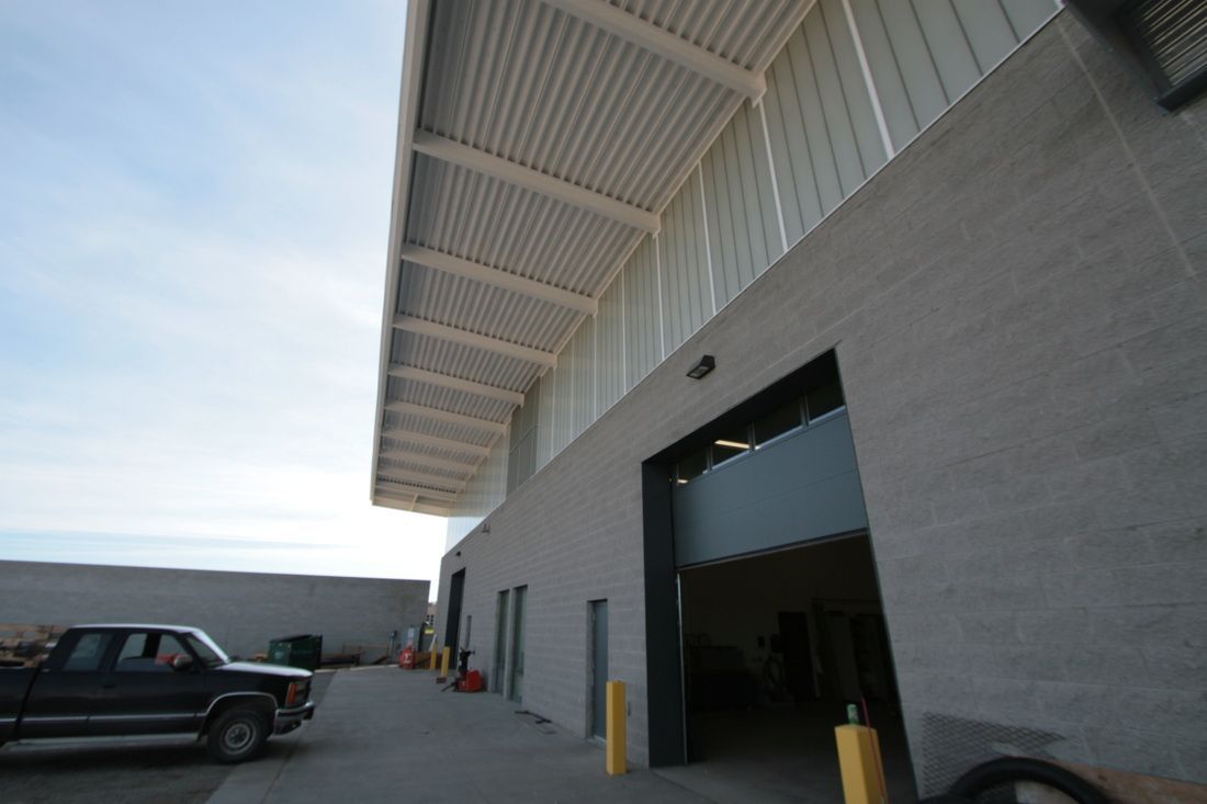 A truck is parked in front of a large building
