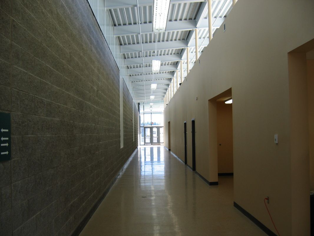 A long hallway with a sign that says 111 on it