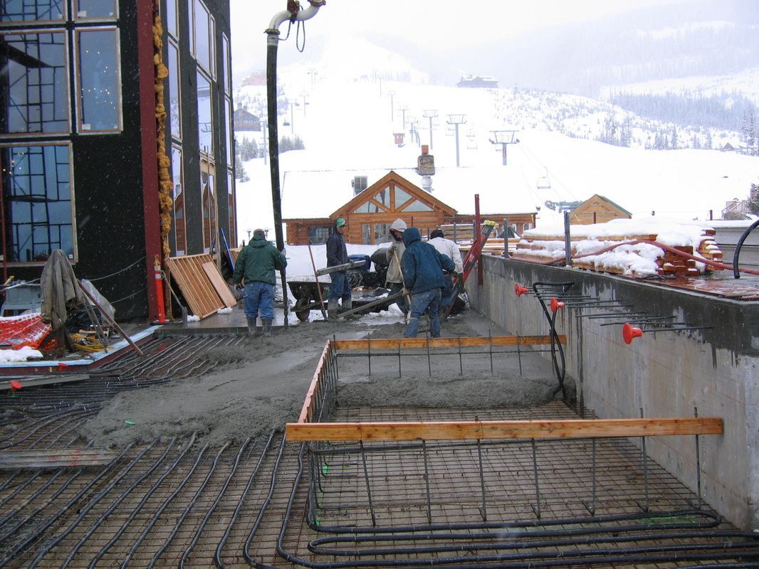 A group of construction workers are working on a building.