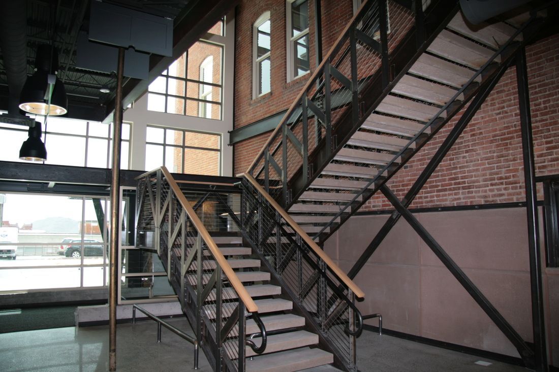 A staircase in a building with a brick wall