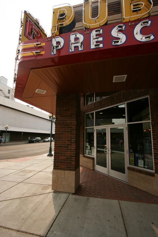 A building with a red sign that says pub presc