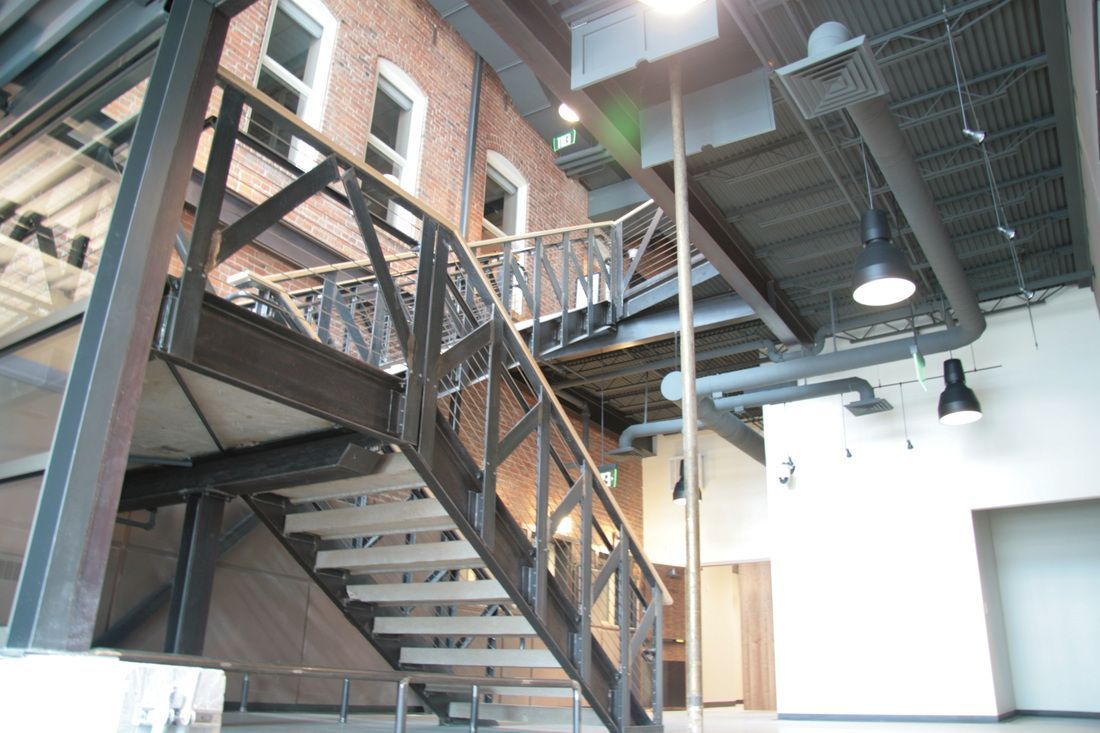 A metal staircase leading up to the second floor of a building