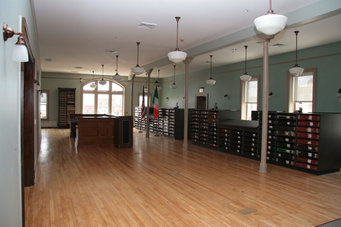 A large room with hardwood floors and lots of shelves