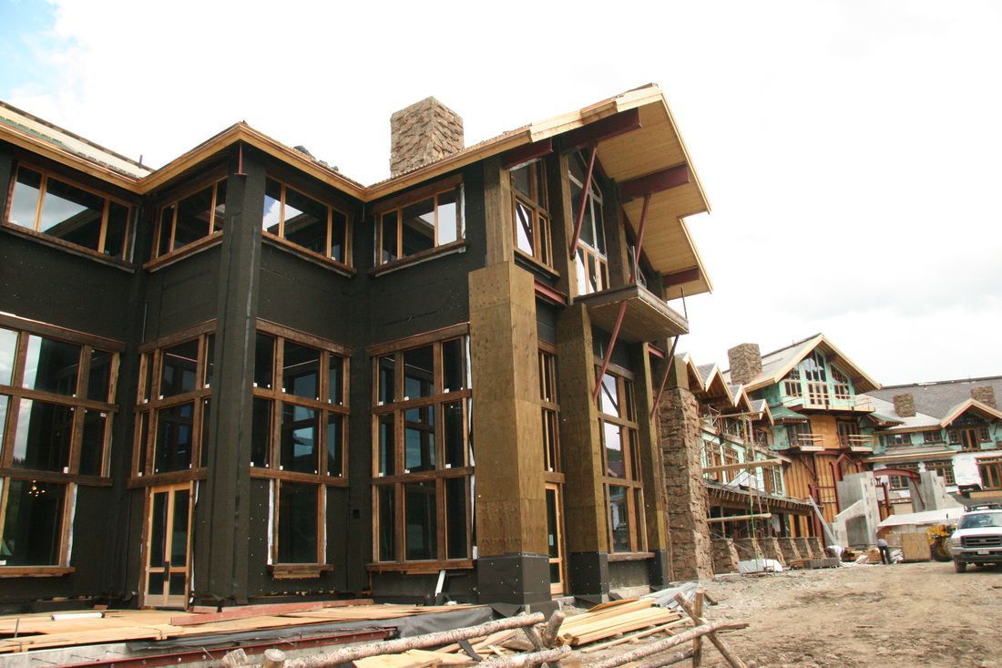 A large house is being built with a lot of windows.