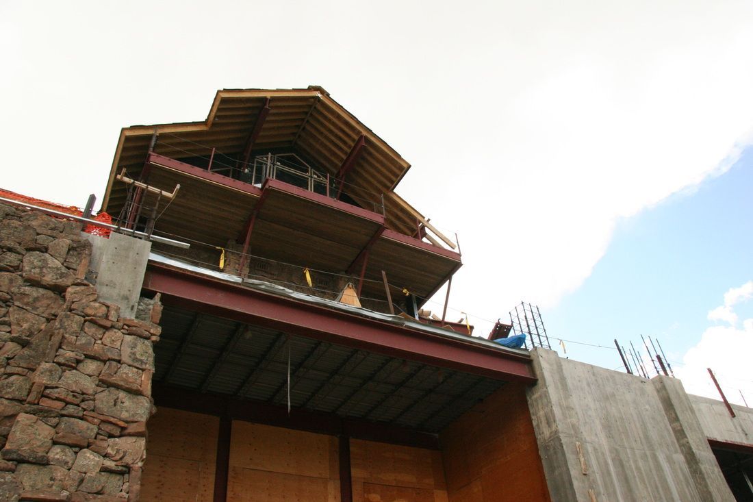 A large building under construction with a wooden roof
