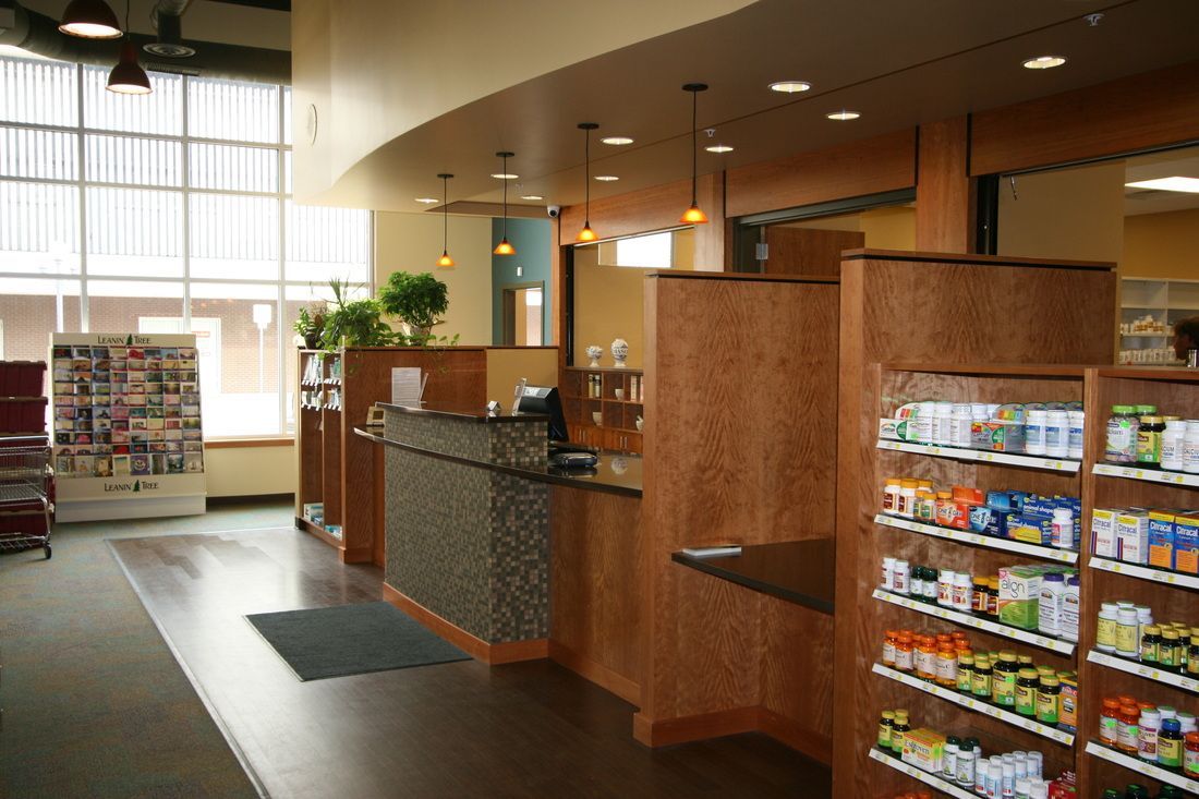The inside of a pharmacy with lots of shelves and a counter