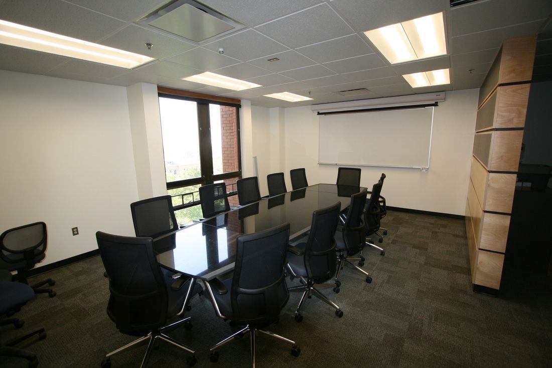 A conference room with a long table and chairs