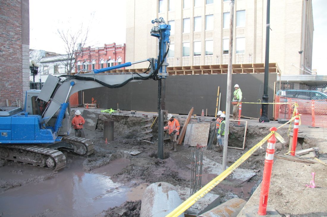 A group of construction workers are working on a construction site.
