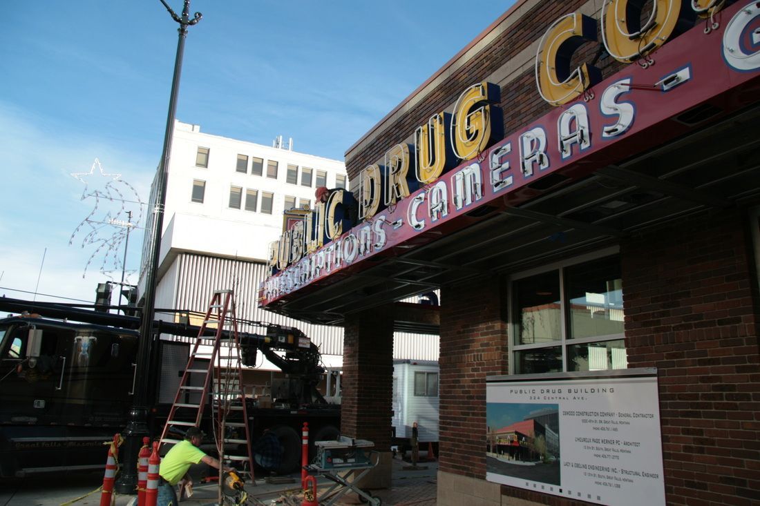 A brick building with a red sign that says drug cameras