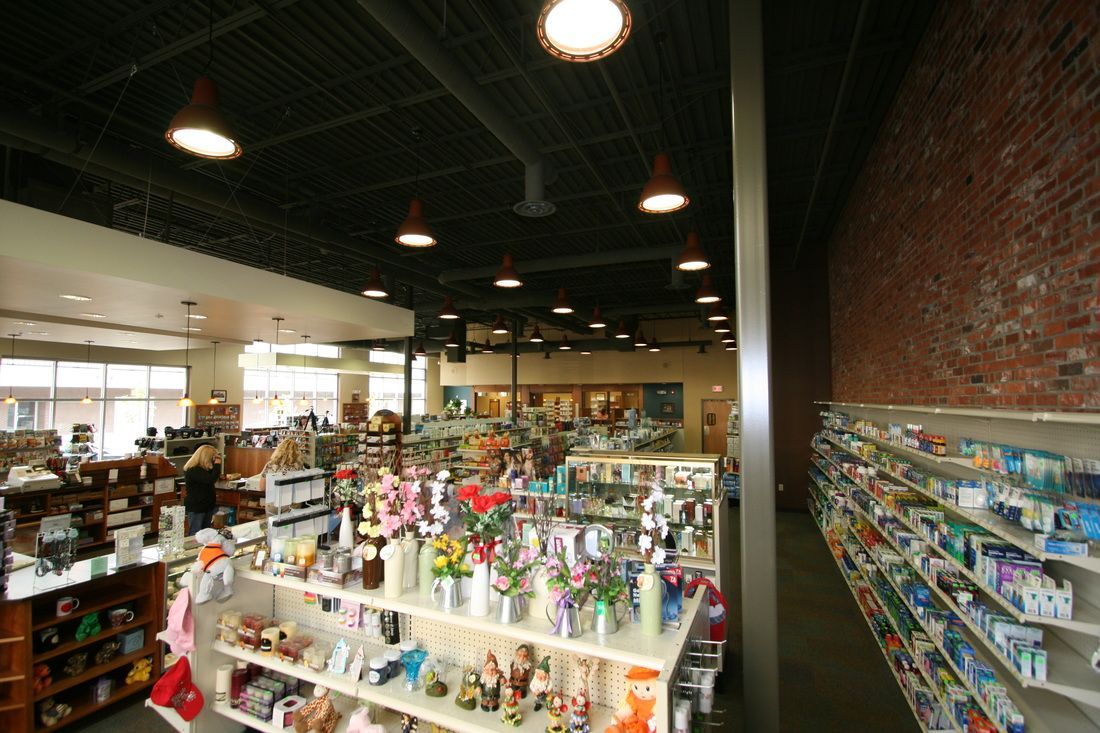 A pharmacy with lots of shelves and a brick wall