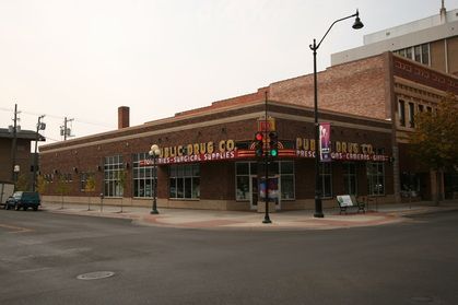 A drug store is located on the corner of a city street