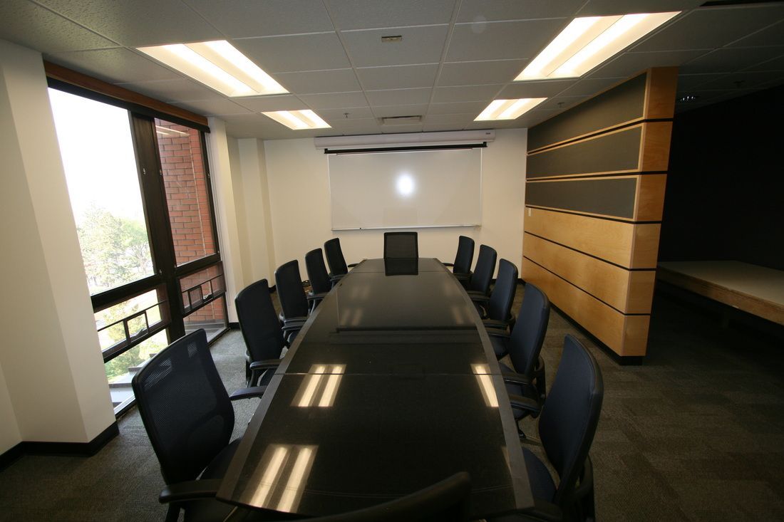 A conference room with a long table and chairs