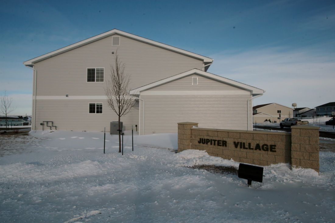 A building with a sign in front of it that says jupiter village.
