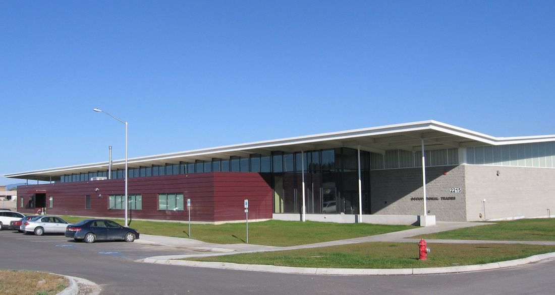 A large building with cars parked in front of it