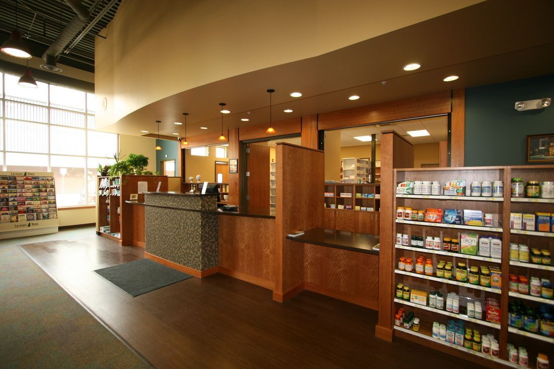 A pharmacy with lots of shelves and a counter